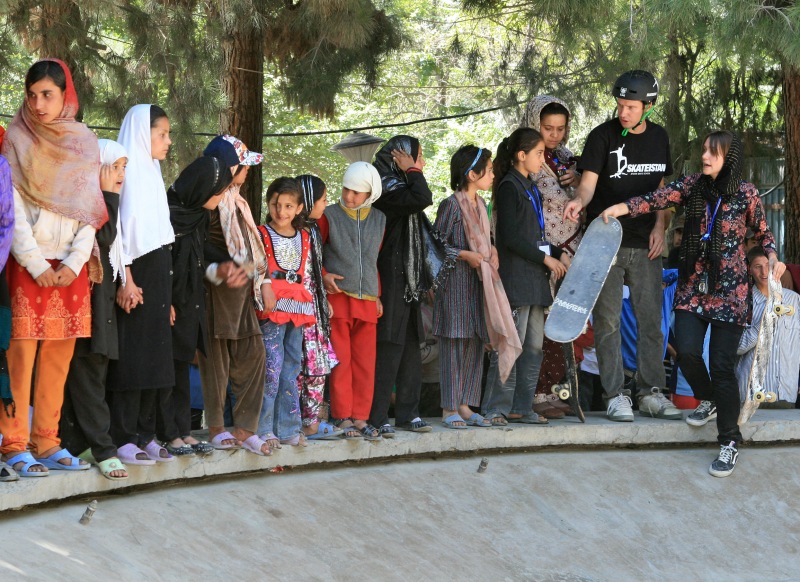 Oliver introduces the magic of skating to a group of Afghan girls at a public fountain in Kabul. 